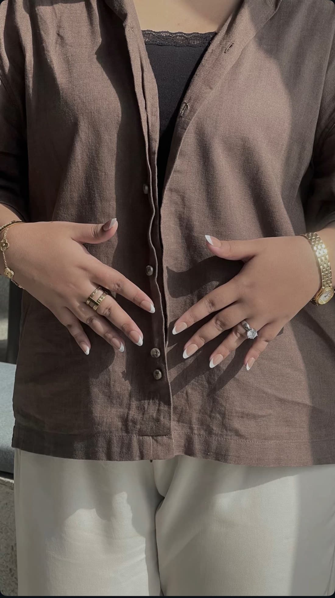 Client wearing white french-tip AYYN. nails